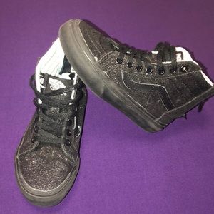 Girls black glitter high top vans.